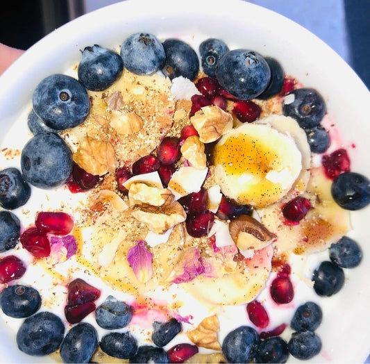 Saffron chia seed porridge with fruit and nuts, vanilla paste and rose petals over Velvet Cloud